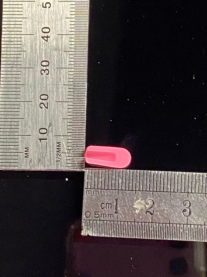 pink silicone end cap, inverse view. measuring base and length against a ruler