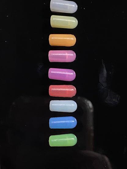row of 9 end caps; white, yellow, orange, hot pink, purple, red, ice blue, dark blue and green