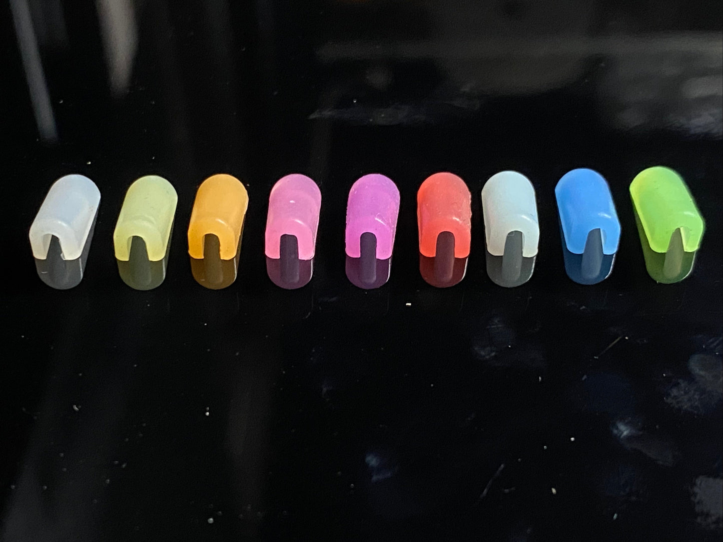 white, yellow, orange, pink, purple, red, ice blue, dark blue and green end caps, bottom view