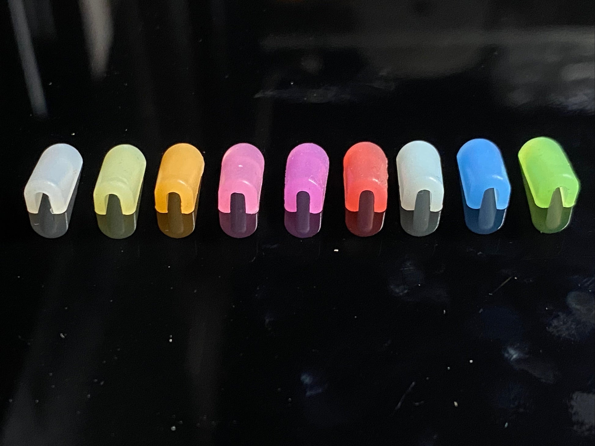 white, yellow, orange, pink, purple, red, ice blue, dark blue and green end caps, bottom view