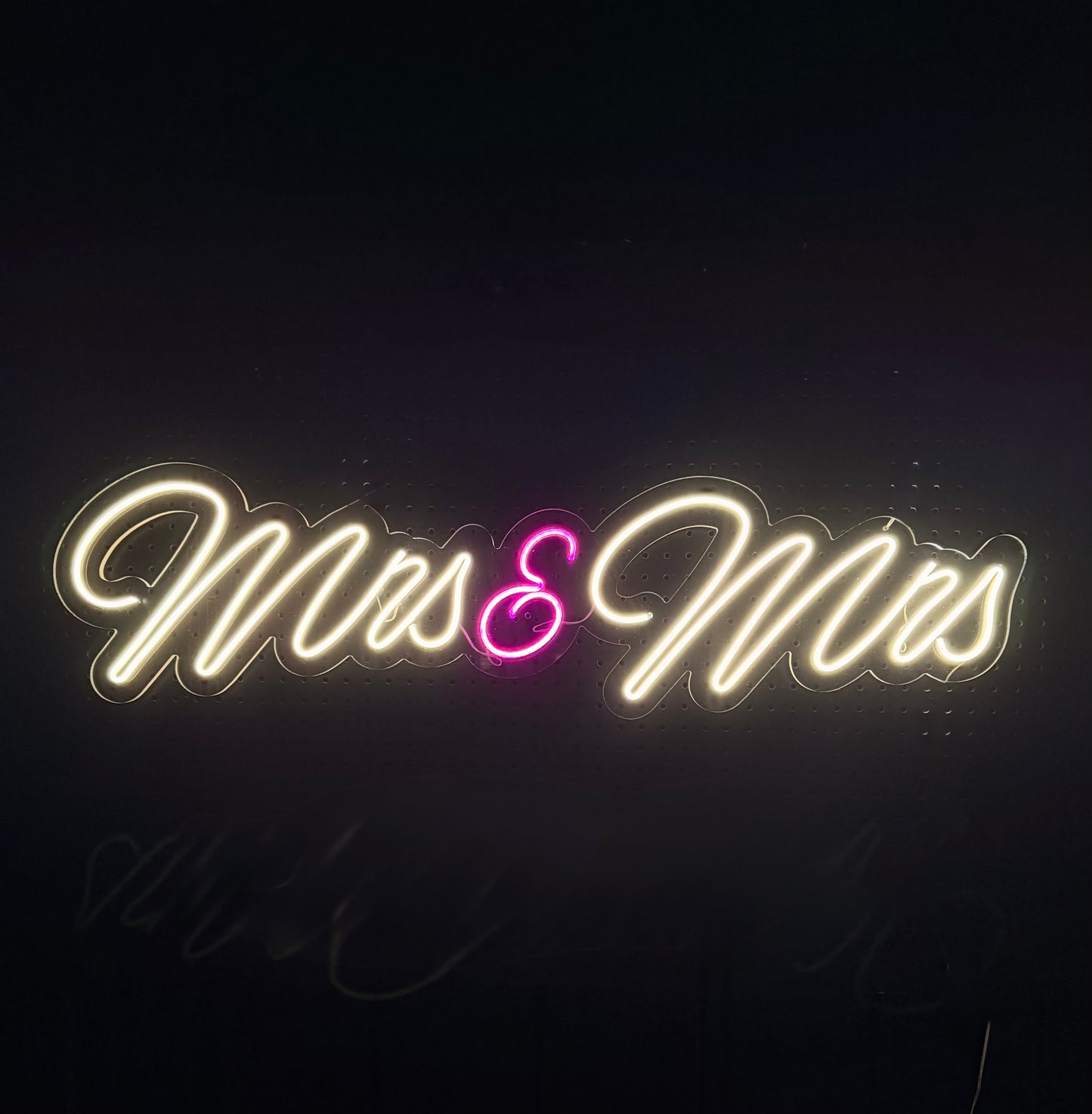 White LED Neon "Mrs & Mrs" cursive with pink ampersand on clear acrylic