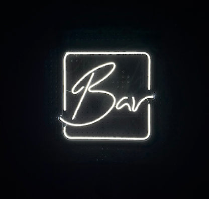 White LED Neon "Bar" cursive in frame on clear acrylic