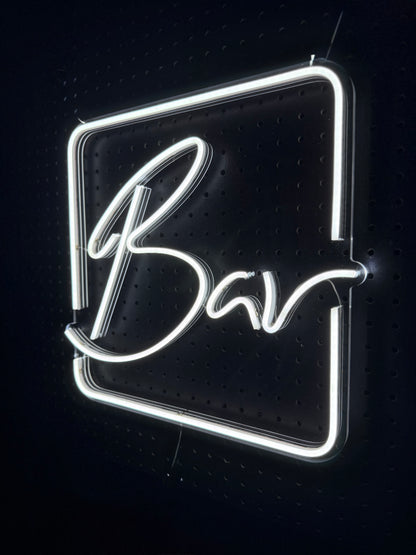 White LED Neon "Bar" cursive in frame on clear acrylic