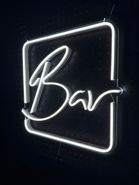 White LED Neon "Bar" cursive in frame on clear acrylic