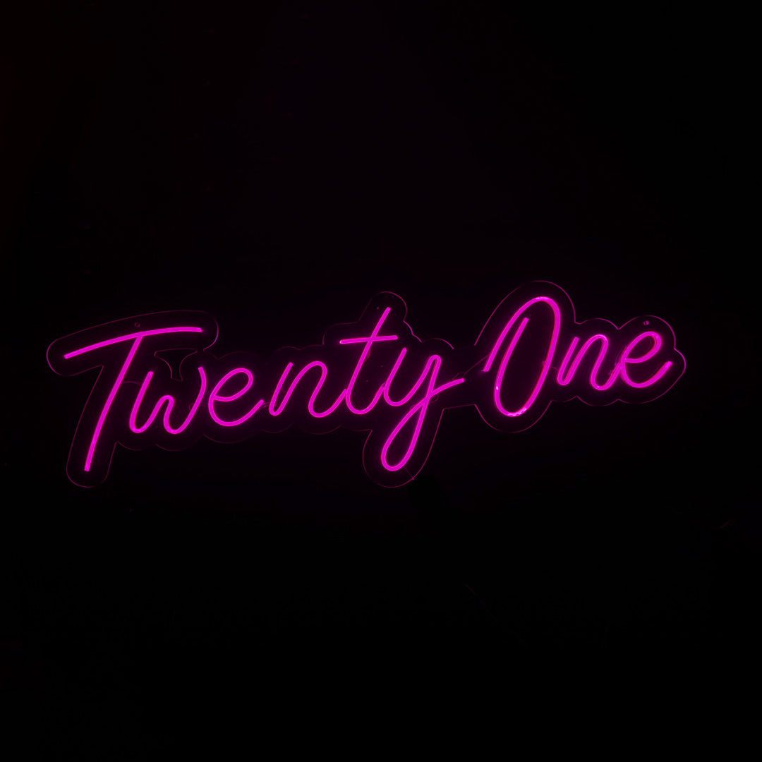 Pink LED Neon "Twenty One" cursive on clear acrylic