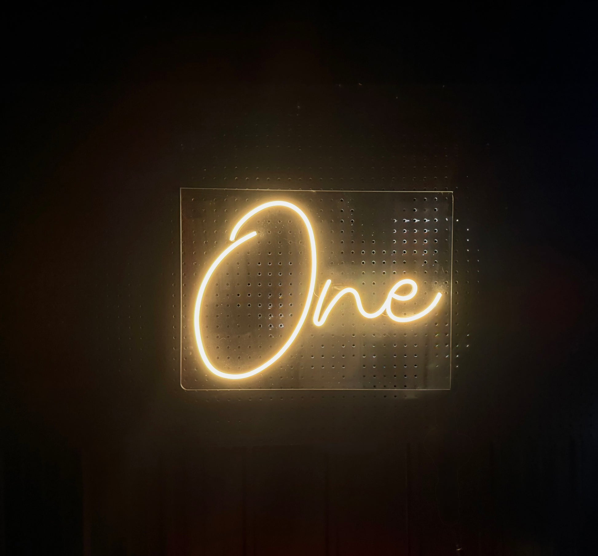 Warm white LED neon sign with the word 'One' on acrylic rectangle