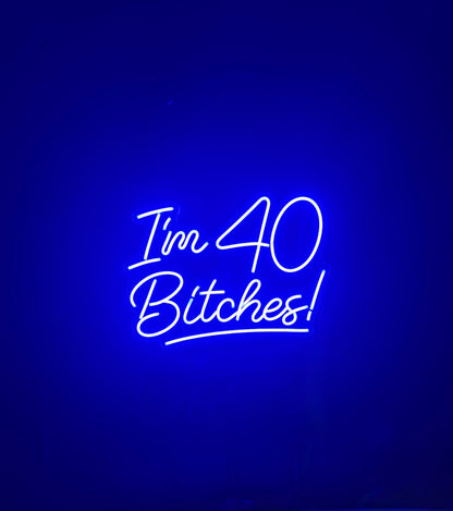 Neon sign with text 'I'm 40 Bitches!' 