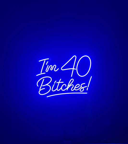 Neon sign with text 'I'm 40 Bitches!' 