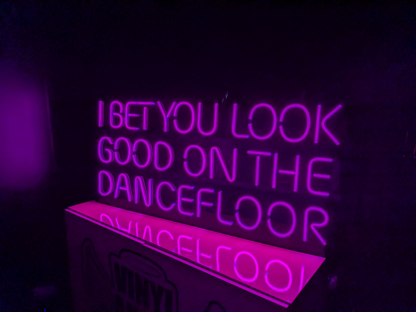Hot Pink LED Neon "I bet you look good on the dancefloor" on smokey black acrylic