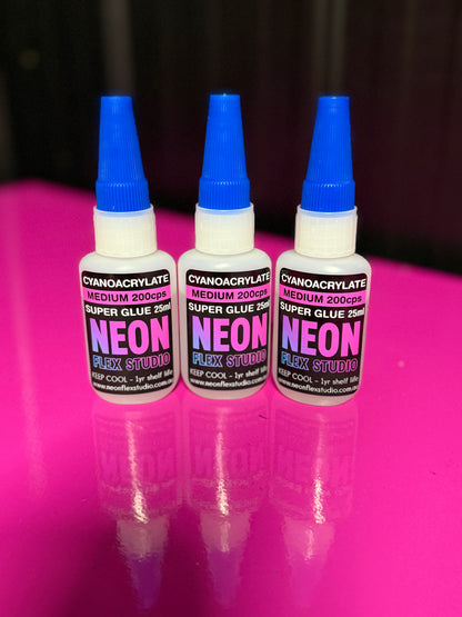 Three bottles of Neon Flex Studio super glue medium viscosity